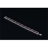 An 18ct white gold, diamond, and black enamel bracelet comprising of curved segments, set with