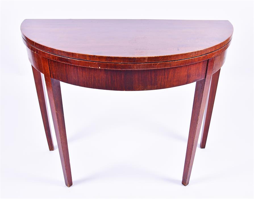 A 19th century mahogany demi-lune card table  opening to reveal green baize, on plain tapering