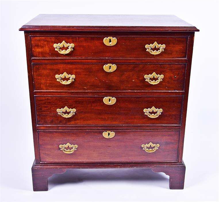 A small Georgian mahogany chest of four graduated drawers with brass handles and escutcheons, on