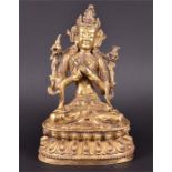 A gilt bronze Tibetan model of a Buddha seated in vajraparyankasana on a double lotus base,