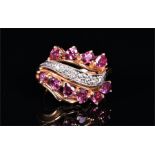 A 14ct yellow gold, diamond and rubellite tourmaline cluster ring the swept mount set with six round