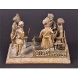 A Raj period Indian cast brass study, seemingly depicting a Court Martial Scene a figure stands with