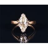 An 18ct yellow gold and marquise diamond ring set with a marquise cut yellow diamond of