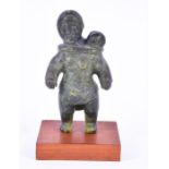 A Canadian Inuit carved soapstone study of a mother carrying a child in a papoose mounted to a