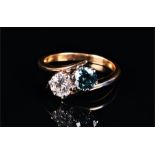 An 18ct yellow gold and blue and white diamond ring the crossover-style mount set with a blue