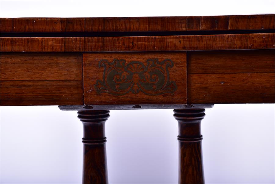 A 19th century rosewood veneered folding card table the top and frieze with brass inlay supported on - Image 2 of 4