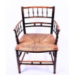 A Victorian oak and stained beech William Morris Sussex chair with rush seat and turned supports,