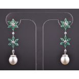 A pair of white metal, diamond, emerald and pearl drop-earrings each set with two floral clusters of