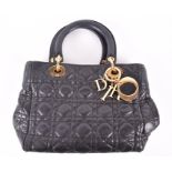 A Dior quilted cannage leather handbag small tote design, with red lined interior, 27 x 18 cm.