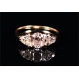 A yellow metal and diamond ring centred with an oval-cut diamond, flanked by six old cut diamonds,