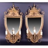 A pair of late Victorian gilt gesso three-branch girondelles in the manner of Robert Adam, of shield