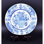 A large mid-19th century Chinese charger decorated in underglaze blue with a central decoration of a