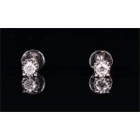 A pair of white metal and diamond ear studs (tests as 9ct white gold) each illusion set with a