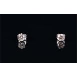 A pair of 18ct white gold and solitaire diamond earrings the round brilliant-cut diamonds of