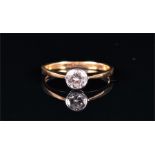 An 18ct yellow gold and solitaire diamond ring set with a round brilliant-cut diamond of