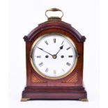 A George III mahogany cased bracket clock the arched case with brass carry handle and fretwork