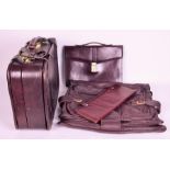 Selected good quality leather travelling accessories to include a set of two suitcases, suit bag,