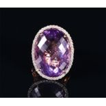 A 14ct yellow gold, diamond, and amethyst cocktail ring set with a large faceted amethyst of