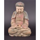 A 19th century Chinese carved wood and painted figure of Buddha seated, with eyes downcast, 23cm