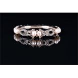 A white metal, diamond, and pearl bracelet the openwork mount set with round brilliant-cut diamonds,