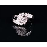 An 18ct white gold and diamond crossover cluster ring set with round brilliant-cut diamonds of