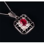 A 14ct white gold, diamond, and ruby pendant the openwork rectangular pendant centred with an oval-