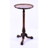A George III style mahogany tripod wine table with piecrust top raised on carved lion paw feet, 75cm