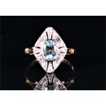 An 18ct yellow gold, diamond, and aquamarine ring in the Art Deco taste, centred with an oval-cut