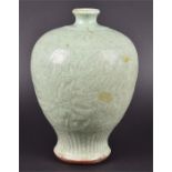 A 17th century Chinese celadon glazed vase of inverted baluster form, the body decorated with