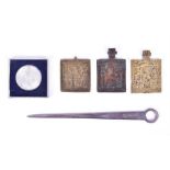 Three Russian relief-decorated brass icons each circa 5cm x 5.5cm, together with a silver letter