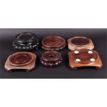 A collection of six assorted Chinese carved hardwood display stands the largest 20cm wide.