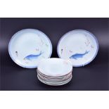 A pair of 20th century Japanese celadon glazed plates each decorated with fish within a repeating