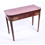 A 19th century mahogany fold-over tea table with rounded edges, and supported on square tapering