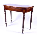 A George III mahogany and inlaid fold-over card table  (lacking baize), raised on turned and