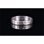 A platinum wedding band with engraved decoration, size N, 2.8 grams.