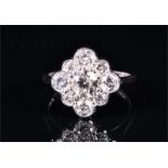 An 18ct white gold and diamond cluster ring centred with a round brilliant-cut diamond surrounded by