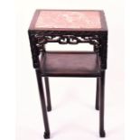 A late 19th century Chinese carved hardwood plant stand of two-tier rectangular form, with inlaid