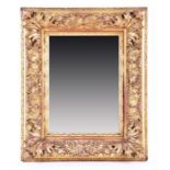 A Victorian heavy gilt gesso framed wall mirror of rectangular form, the frame profusely decorated