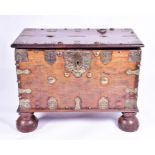 A 19th Century Ceylonese brass mounted wooden chest supported on large pad front feet, the hinged