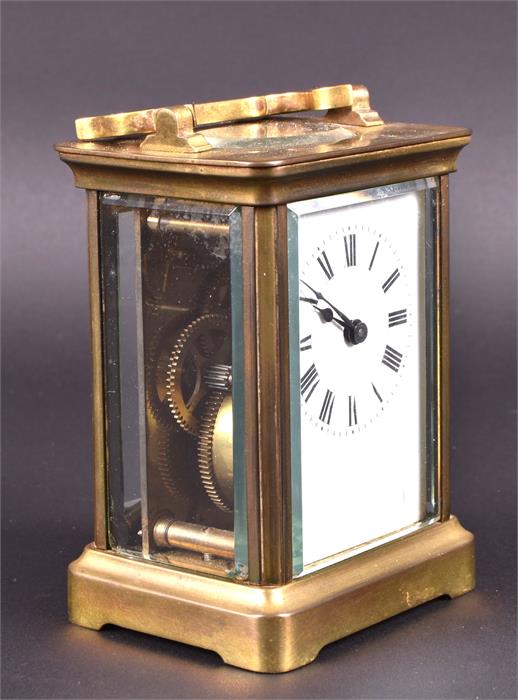 A small late 19th/early 20th century brass carriage clock the white dial with black Roman - Image 2 of 2