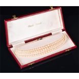 A triple strand pearl necklace of Osaki pearls, with sterling silver and marcasite clasp, in