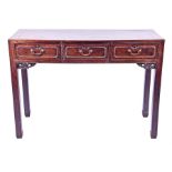 A 19th century Chinese carved hardwood altar table the caddy top with three panelled frieze drawers,