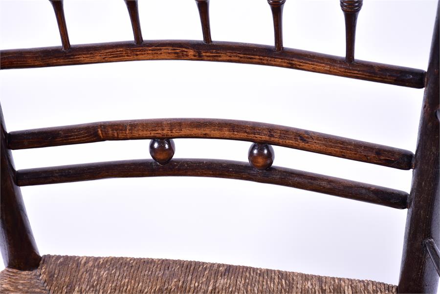 A Victorian oak and stained beech William Morris Sussex chair with rush seat and turned supports, - Image 4 of 5