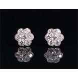 A pair of 18ct white gold and diamond floral cluster ear studs each set with seven round brilliant-
