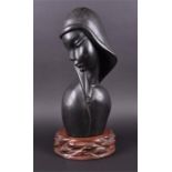 An Eastern carved ebonised hardwood bust depicting a young lady, believed to be South-Asian in