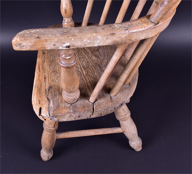 An early 20th century child's Windsor style armchair raised on turned supports, 65cm high x 33cm - Image 3 of 3