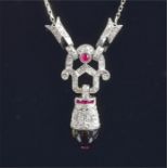 An 18ct white gold, diamond, ruby and onyx drop pendant necklace in the Art Deco taste, the hinged
