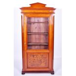 A late 19th Century French walnut bookcase with pointed half-pediment surmount, over a glazed and