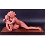 A terracotta coloured figural study of a lunging woman fiercely protecting her crying child signed J