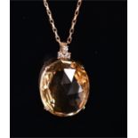 A yellow metal, diamond, and citrine pendant (mount tests as gold), set with a large faceted oval